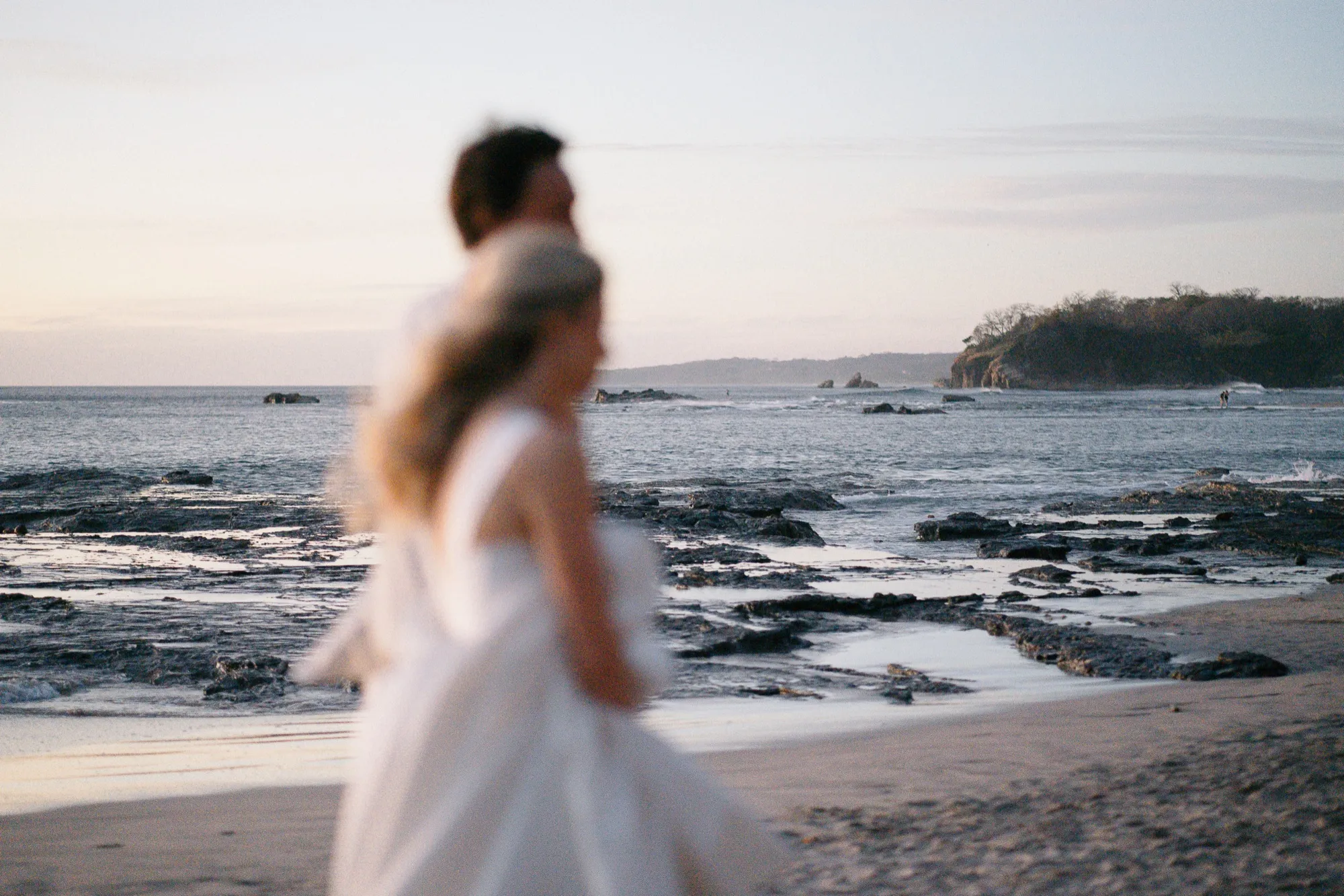Newlyweds soft-focus on the beach at dusk along the Nosara coast